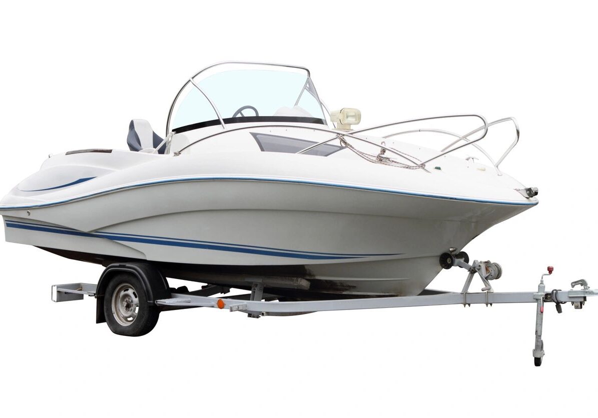 White motor boat loaded on the trailer for transportation.